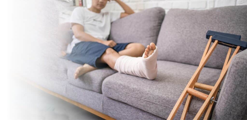 injured person sitting on couch